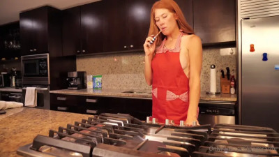 Cooking session with apron-wearing redhead